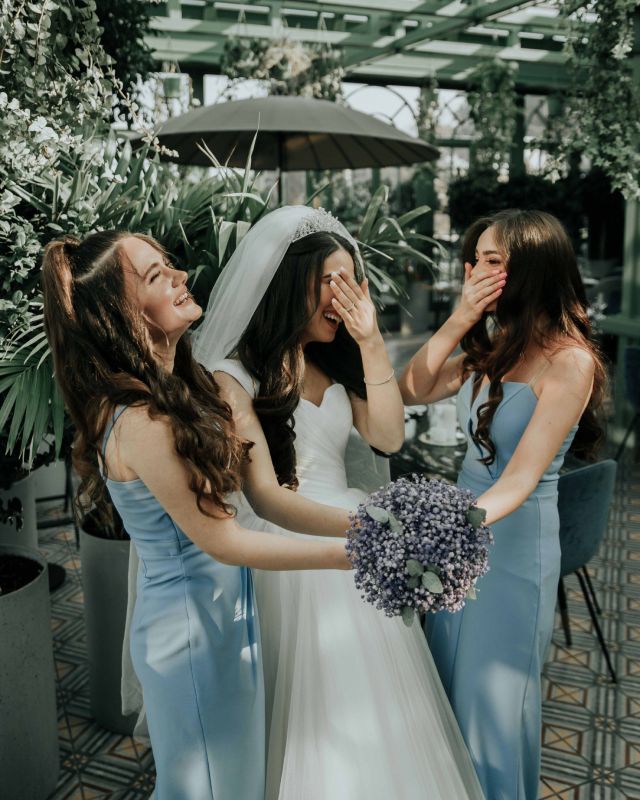 Bridesmaids laughing with the bride